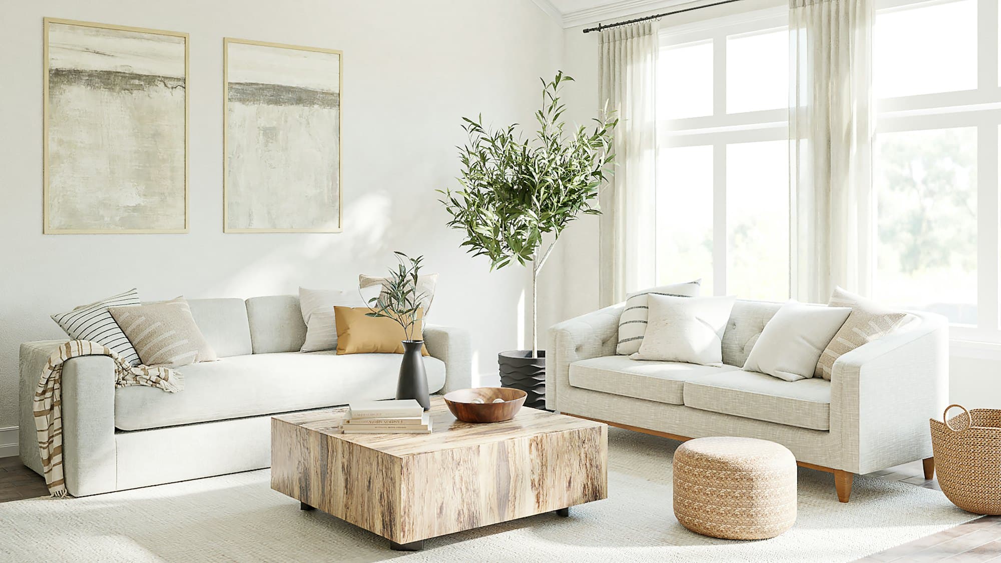 A bright living room with pale sofas and tall windows